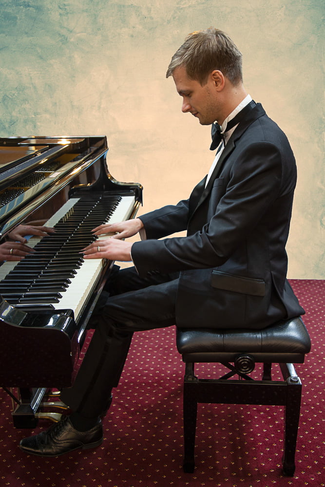 profile shot of Josh at the piano